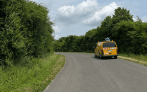 Car with SDK-Compact on roof driving on a road scanning